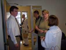A plebe talking with her sponsor family following Plebe Summer Worship.